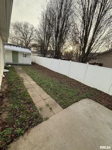 a view of a backyard with a large tree