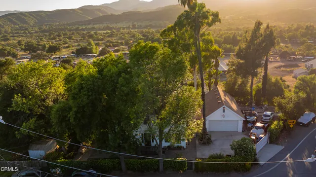a view of a house with a yard and mountain