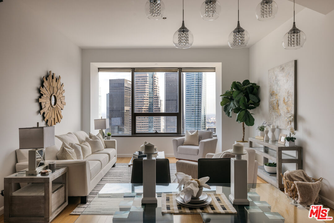 1100 Wilshire Boulevard, Unit 3206 Los Angeles, CA 90017 - Photo 1 of 32 a living room with furniture and floor to ceiling windows
