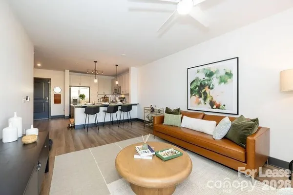 a living room with furniture and a wooden floor