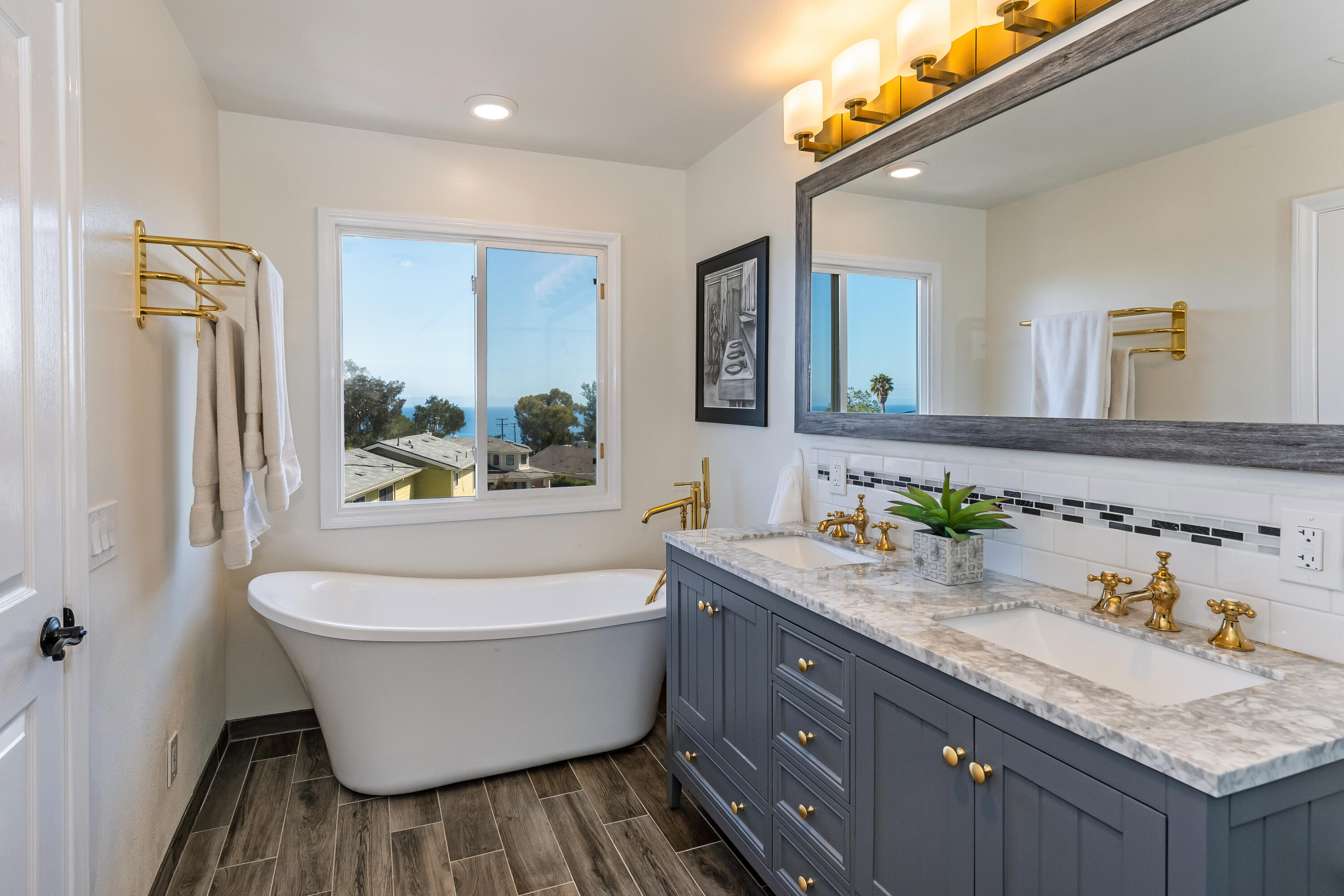 222 Meigs Road, Unit 16 Santa Barbara, CA 93109 - Photo 15 of 26 a bathroom with a granite countertop tub sink and mirror