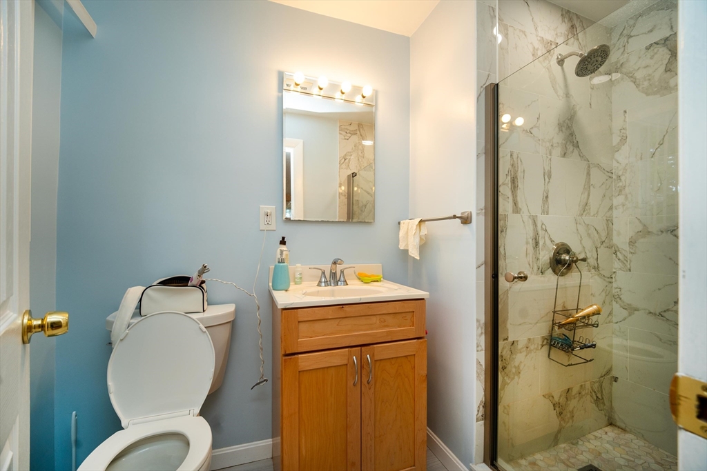 6 Tufts Road, Unit 6 Lexington, MA 02421 - Photo 25 of 25 a bathroom with a toilet sink and mirror
