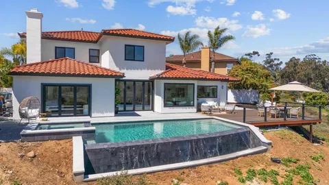 a front view of a house with swimming pool having outdoor seating