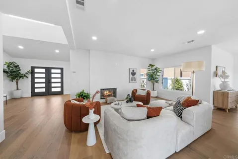 a living room with fireplace furniture and a wooden floor