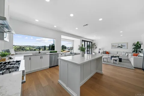a kitchen with counter top space a sink appliances and cabinets