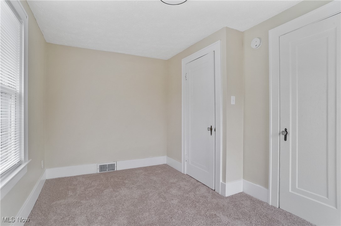 646 Brittain Road Akron, OH 44305 - Photo 27 of 36 Carpeted room featuring baseboards and visible vents