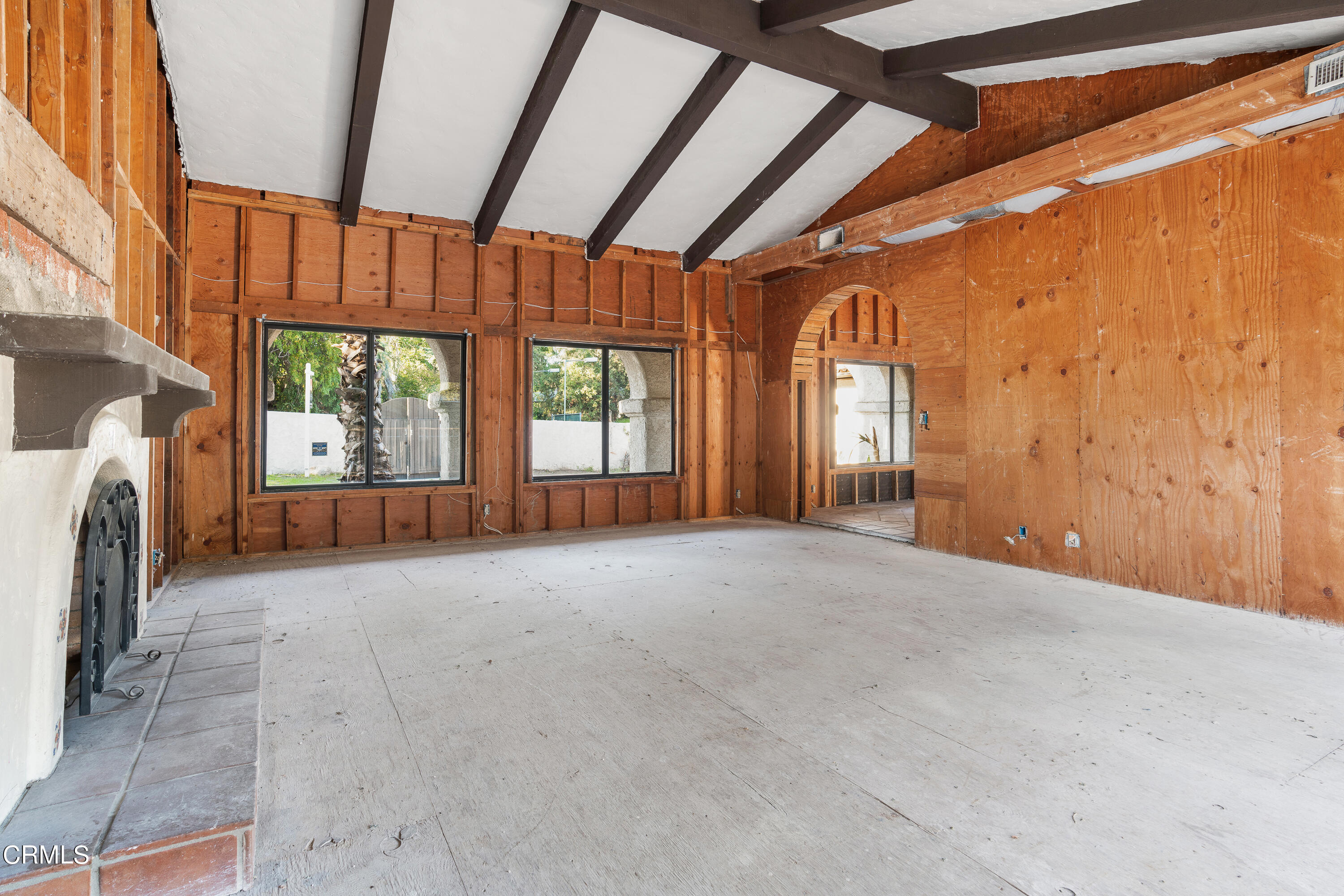 853 Chapea Road Pasadena, CA 91107 - Photo 8 of 32 a view of an empty room with a fireplace and a window