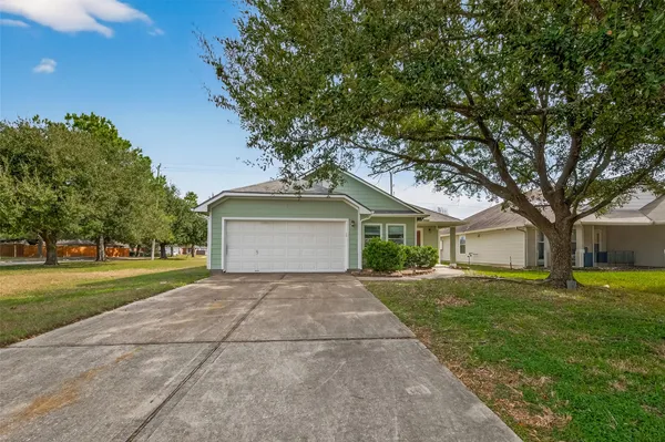 a front view of a house with a yard and trees