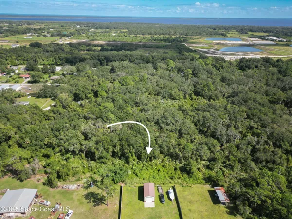 a view of a field with an ocean view
