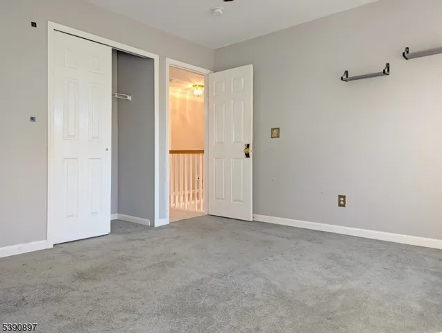 a view of an empty room and closet area