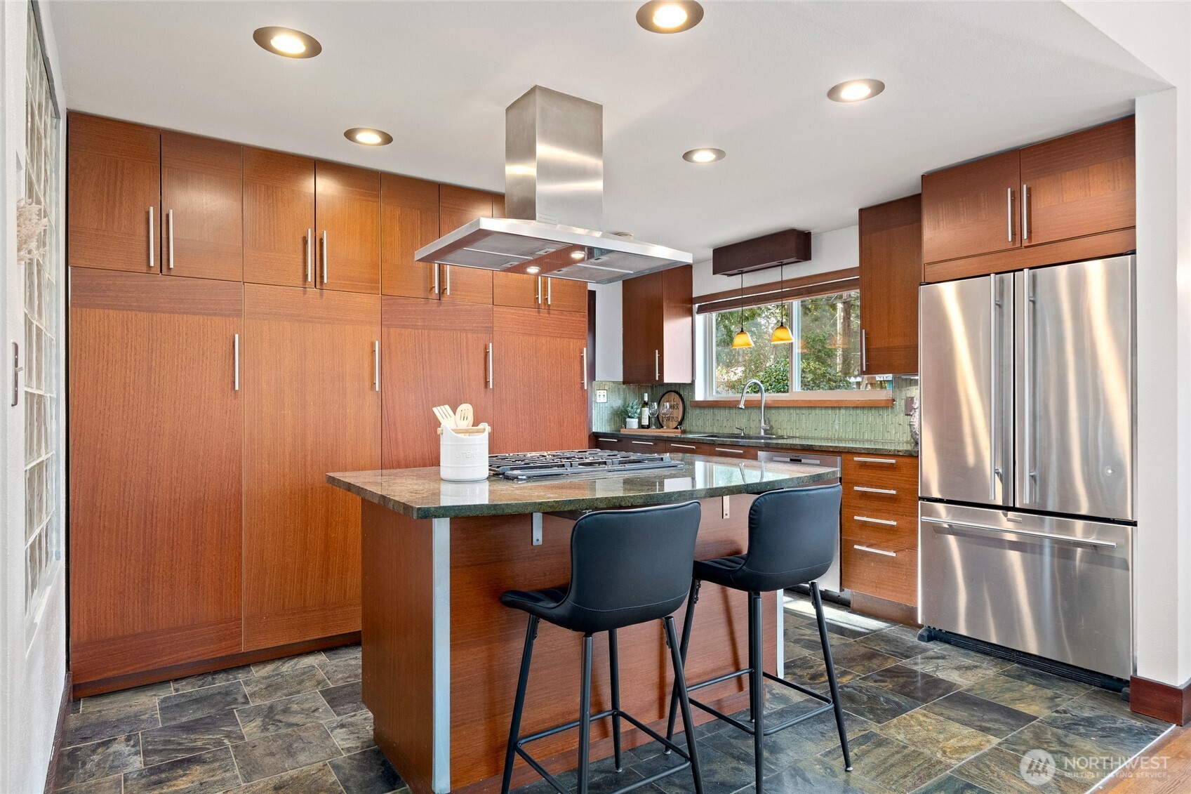 808 Alameda Avenue Fircrest, WA 98466 - Photo 9 of 39 a kitchen with stainless steel appliances granite countertop a refrigerator a sink dishwasher a dining table and chairs with wooden floor