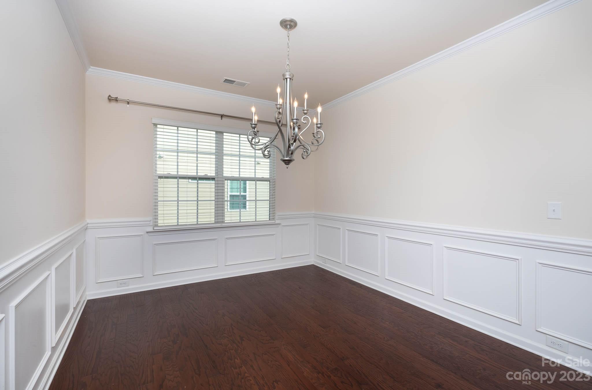 1609 Tranquility Boulevard Lancaster, SC 29720 - Photo 11 of 35 a view of a room with wooden floor and chandelier