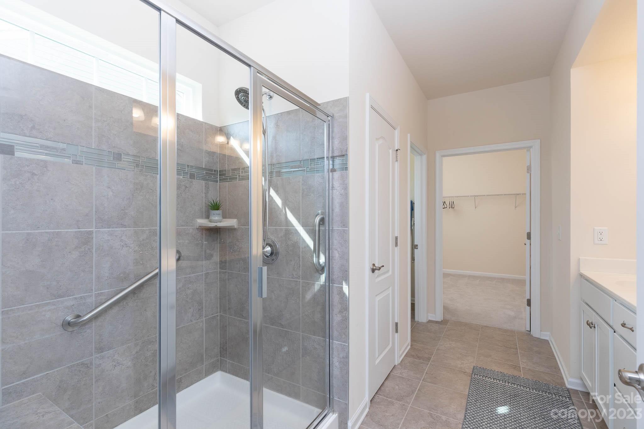 1609 Tranquility Boulevard Lancaster, SC 29720 - Photo 14 of 35 a bathroom with a glass shower door