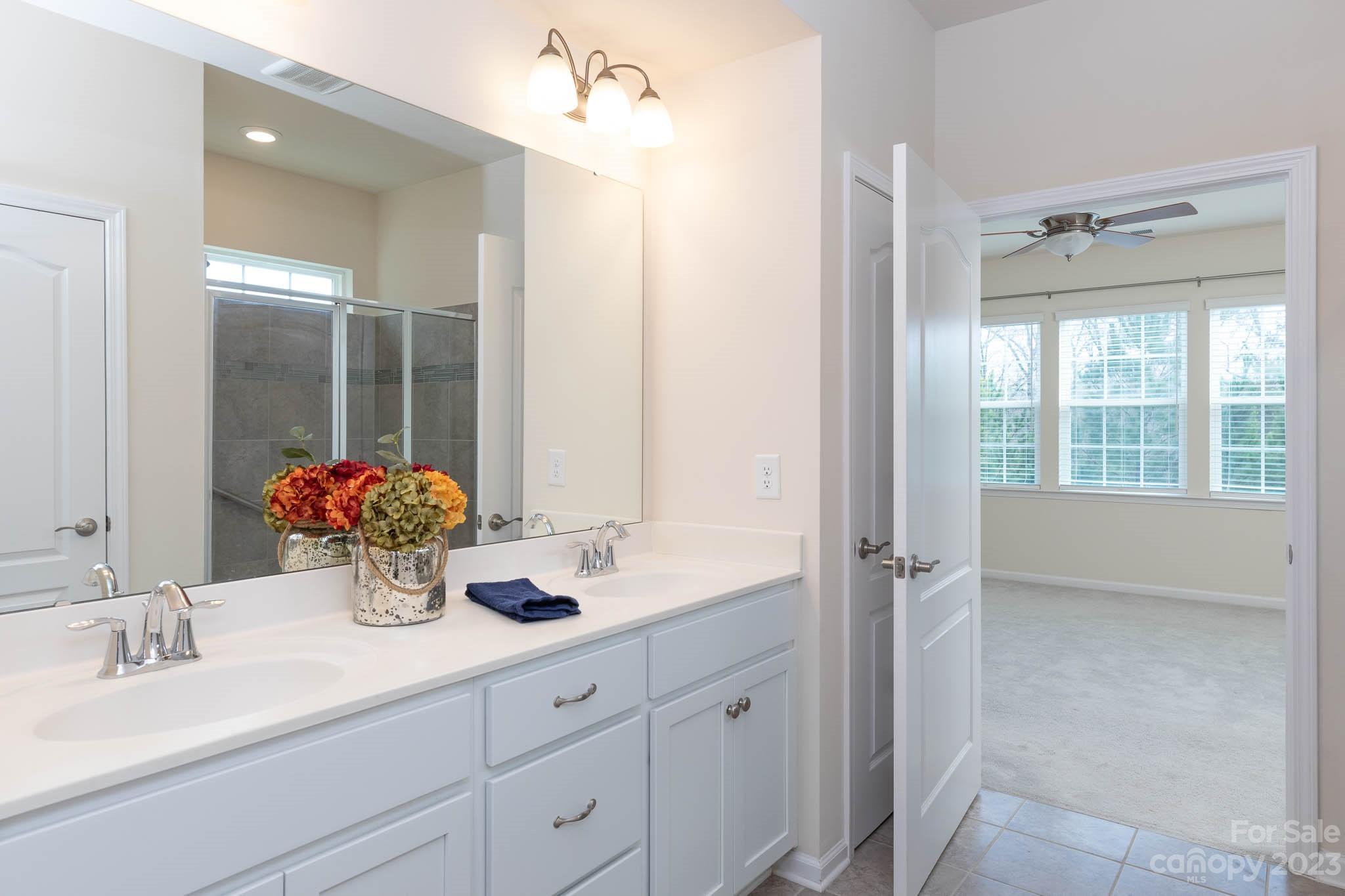 1609 Tranquility Boulevard Lancaster, SC 29720 - Photo 15 of 35 a bathroom with a double vanity sink mirror and next to a window