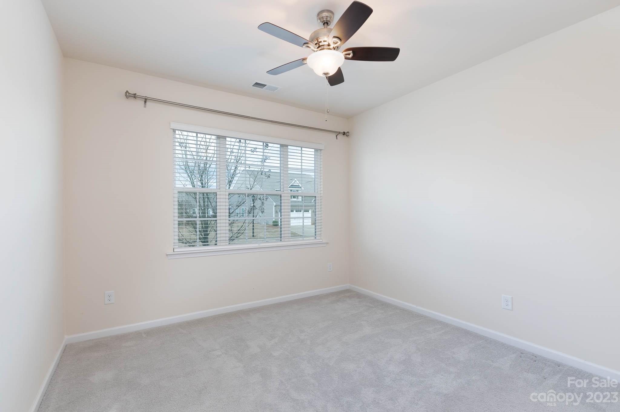 1609 Tranquility Boulevard Lancaster, SC 29720 - Photo 17 of 35 an empty room with a window and a fan