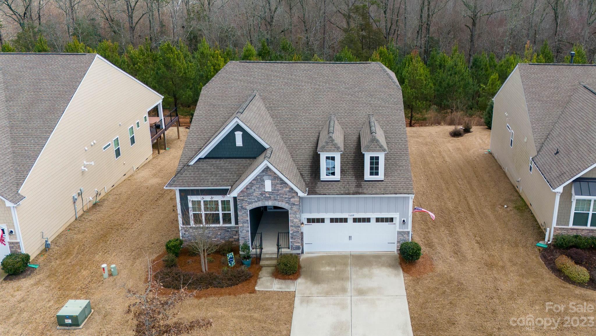 1609 Tranquility Boulevard Lancaster, SC 29720 - Photo 34 of 35 a aerial view of a house with a yard and garage