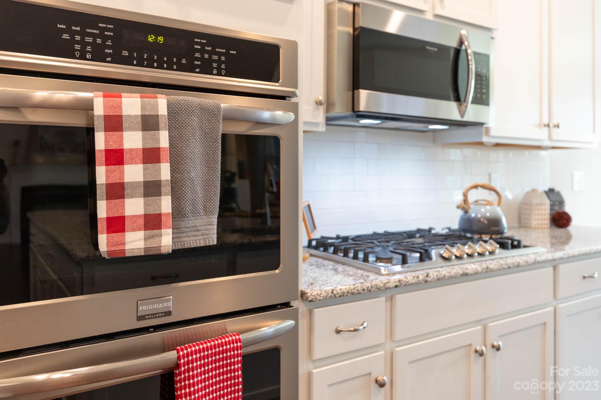 1609 Tranquility Boulevard Lancaster, SC 29720 - Photo 7 of 35 a kitchen with stainless steel appliances white cabinets and a stove top oven