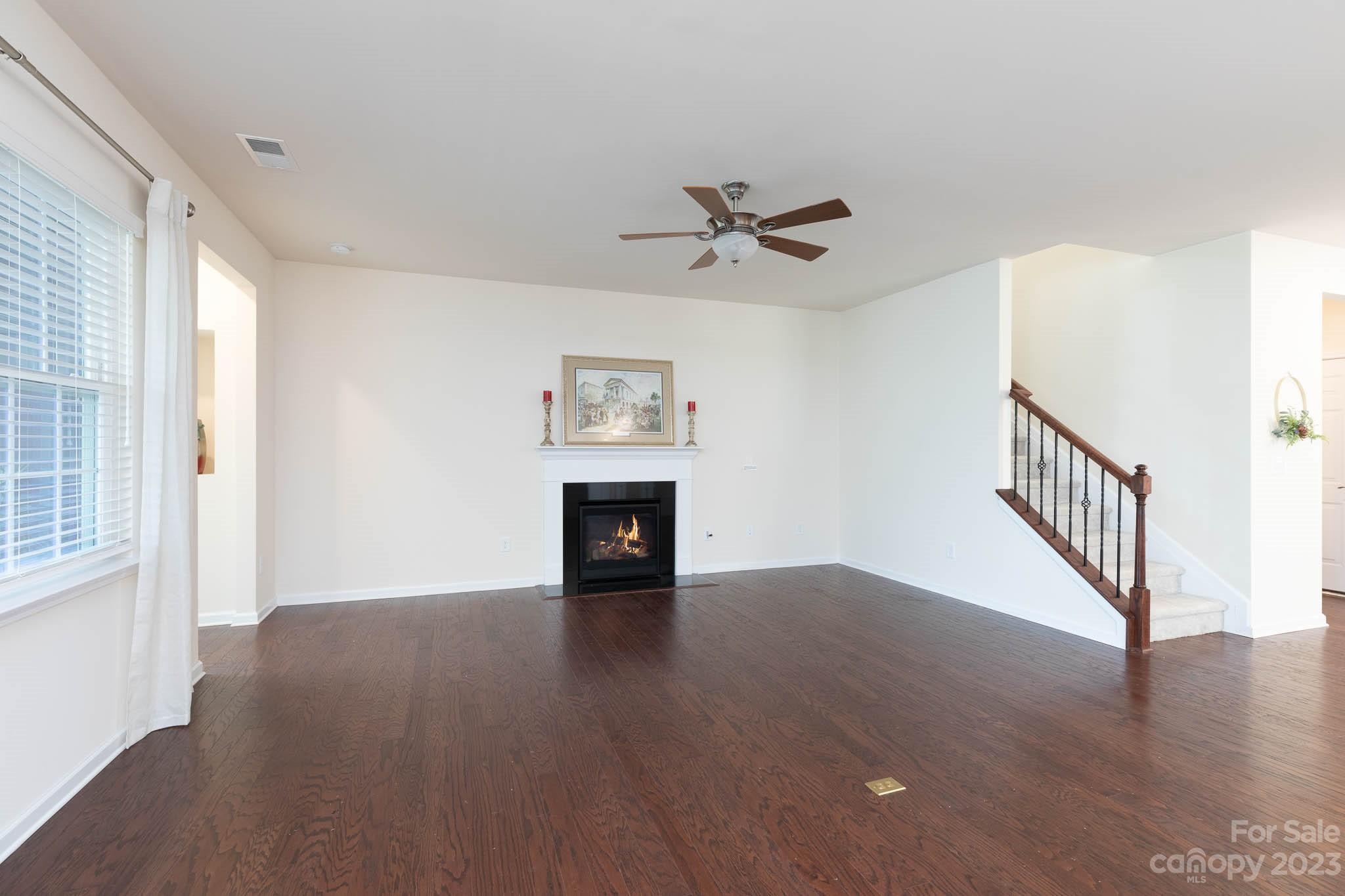 1609 Tranquility Boulevard Lancaster, SC 29720 - Photo 10 of 35 a view of an empty room with wooden floor and a window