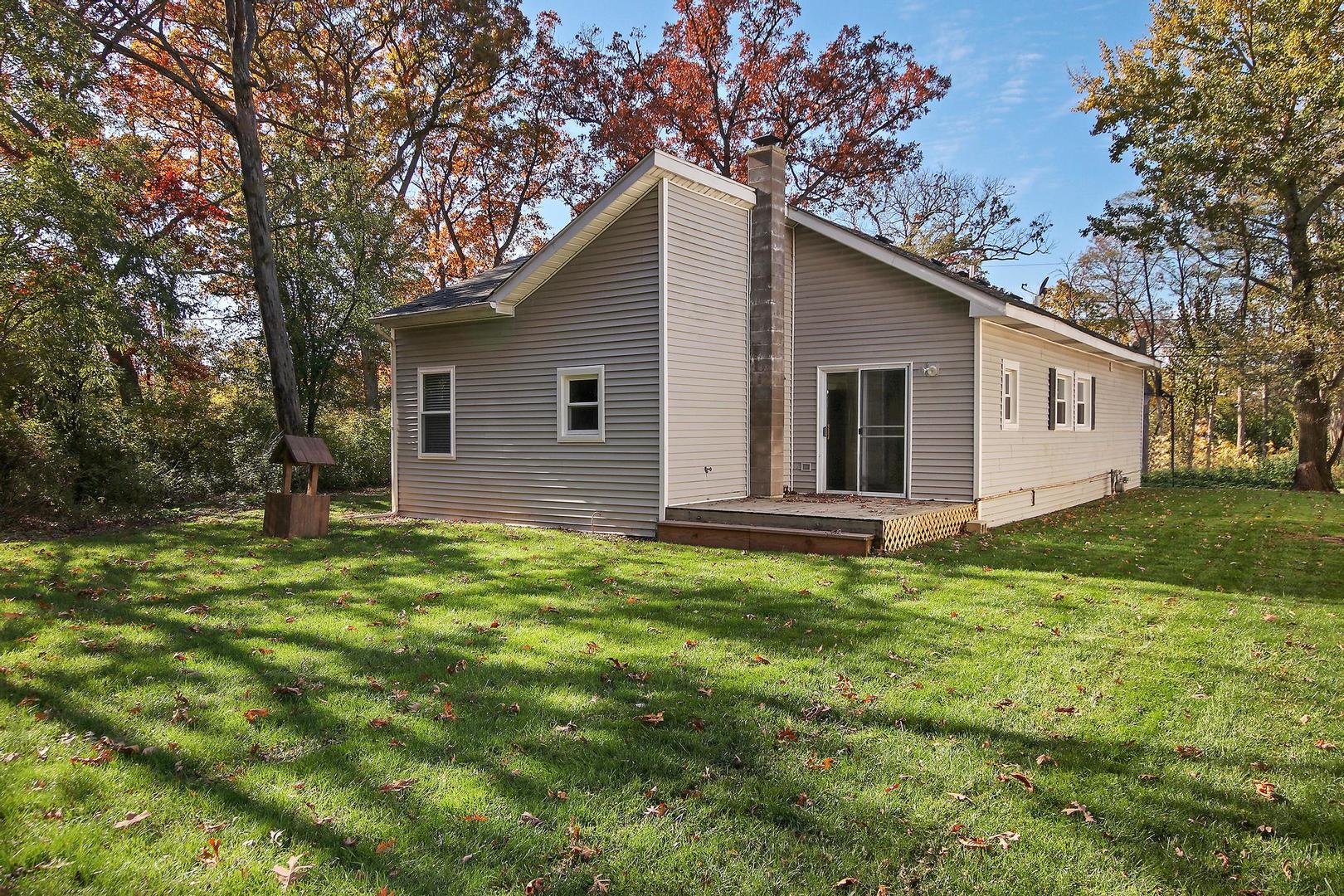 35835 North Benjamin Avenue Ingleside, IL 60041 - Photo 16 of 17 a backyard of a house with plants and large tree