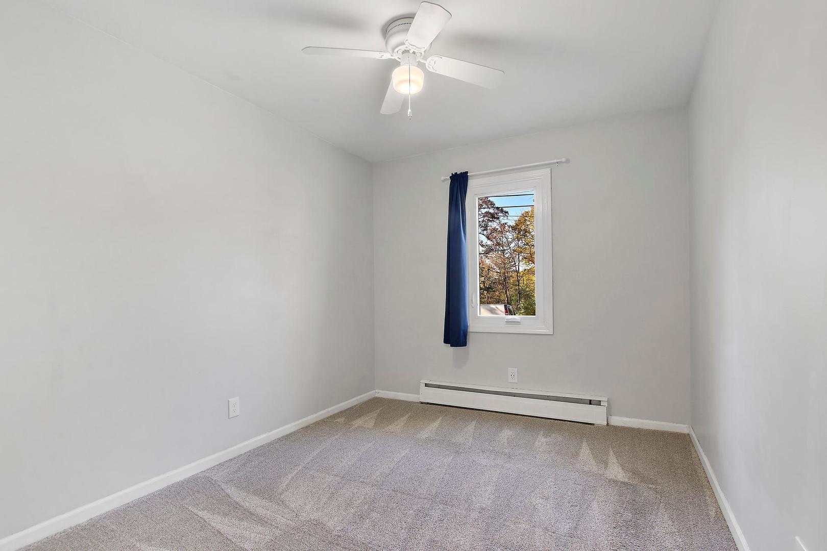 35835 North Benjamin Avenue Ingleside, IL 60041 - Photo 5 of 17 an empty room with a window and a fan