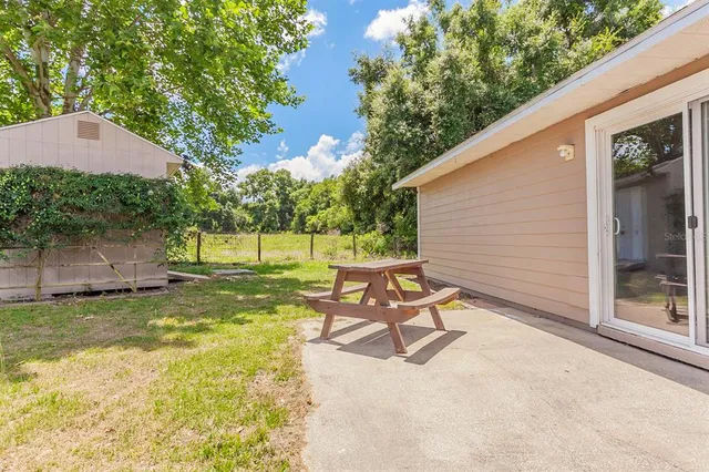 a view of a patio with table and chairs under an umbrella