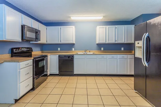 a kitchen with stainless steel appliances cabinets a sink and a counter top space