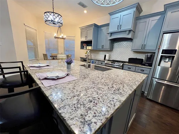 a kitchen with stainless steel appliances granite countertop a stove oven and a counter space