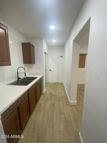 a view of a kitchen with a sink and a mirror