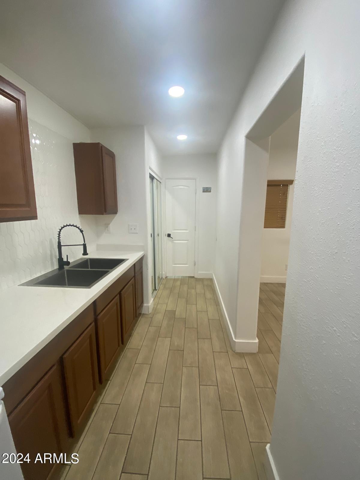 1613 West Mountain View Road, Unit B Phoenix, AZ 85021 - Photo 7 of 10 a view of a kitchen with a sink and a mirror