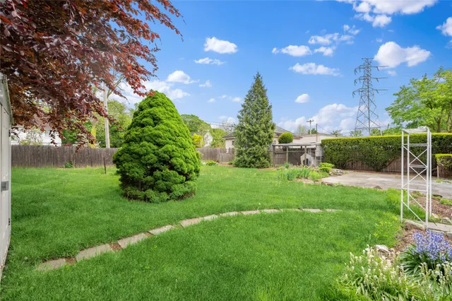a view of a garden with a house