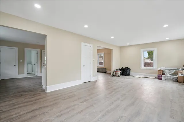 a view of a room with wooden floor and furniture