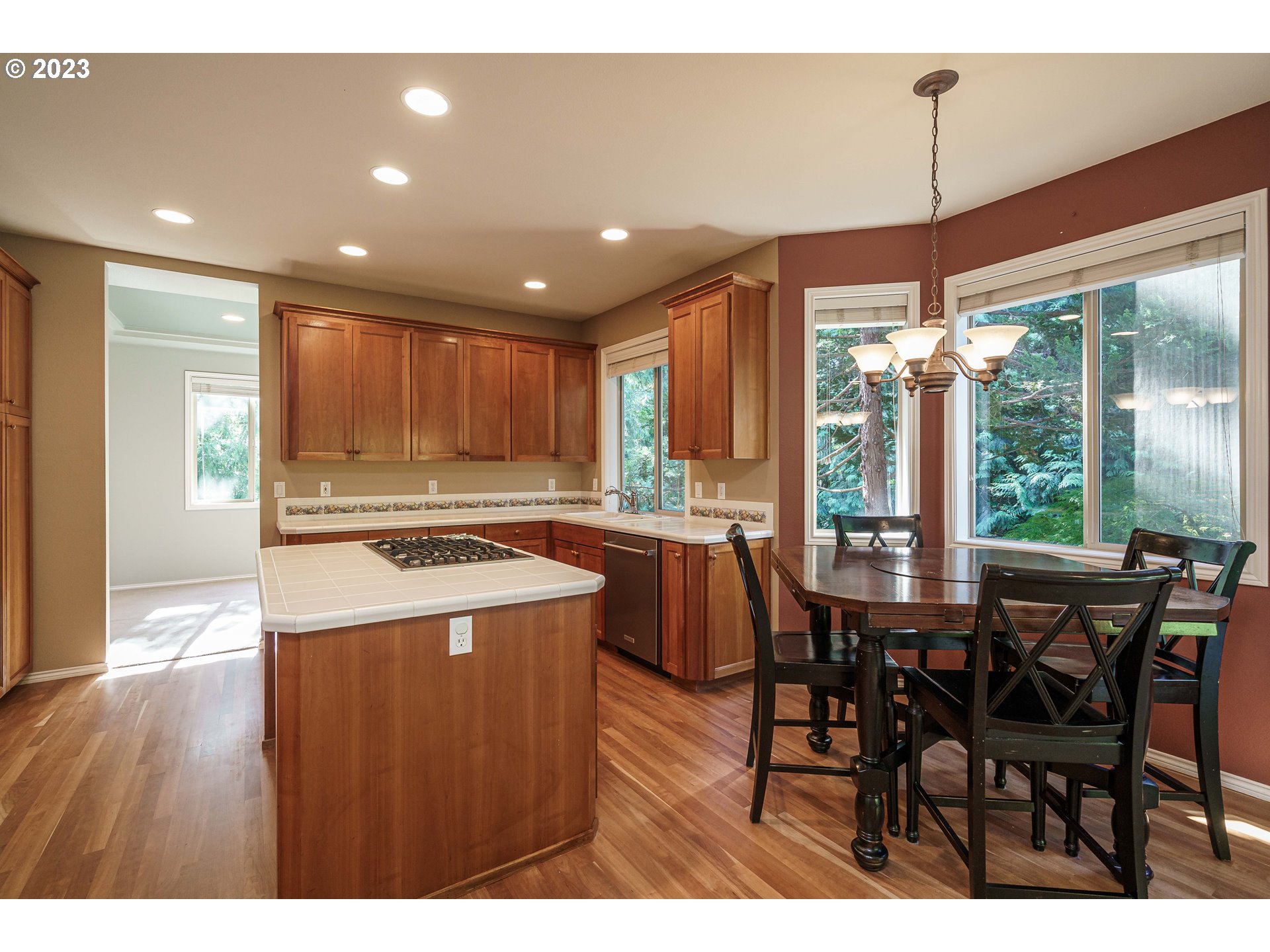 1601 Southeast Elliott Avenue Gresham, OR 97080 - Photo 9 of 48 a kitchen with stainless steel appliances granite countertop a table chairs and a refrigerator