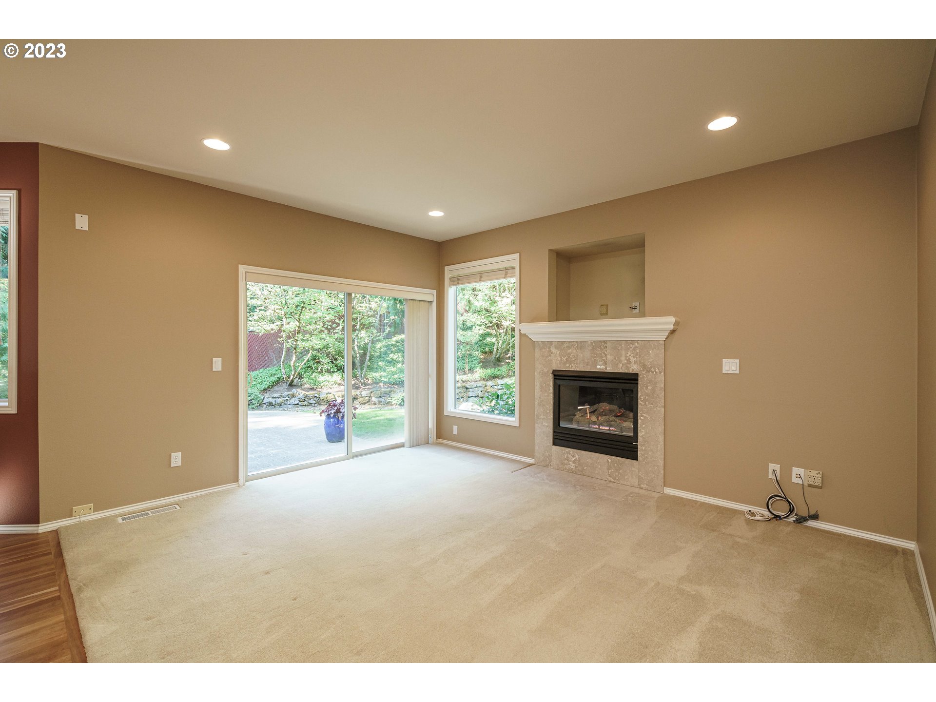 1601 Southeast Elliott Avenue Gresham, OR 97080 - Photo 10 of 48 a view of an empty room with a fireplace and a window