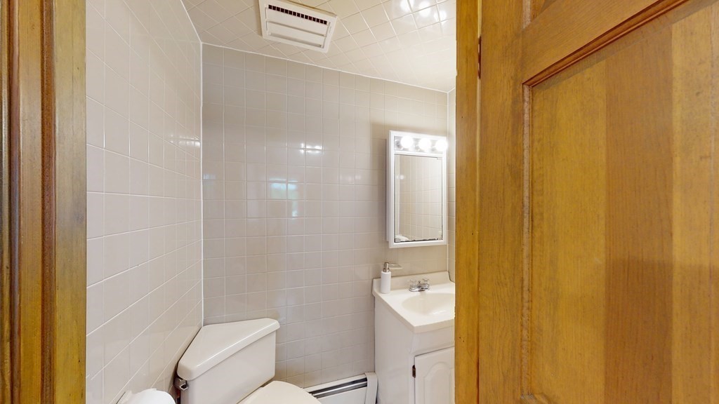 82 Roberts Road Medford, MA 02155 - Photo 11 of 30 a bathroom with a granite countertop sink and a mirror