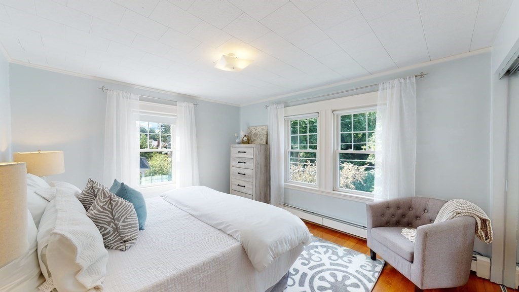 82 Roberts Road Medford, MA 02155 - Photo 12 of 30 a bedroom with a bed and wooden floor