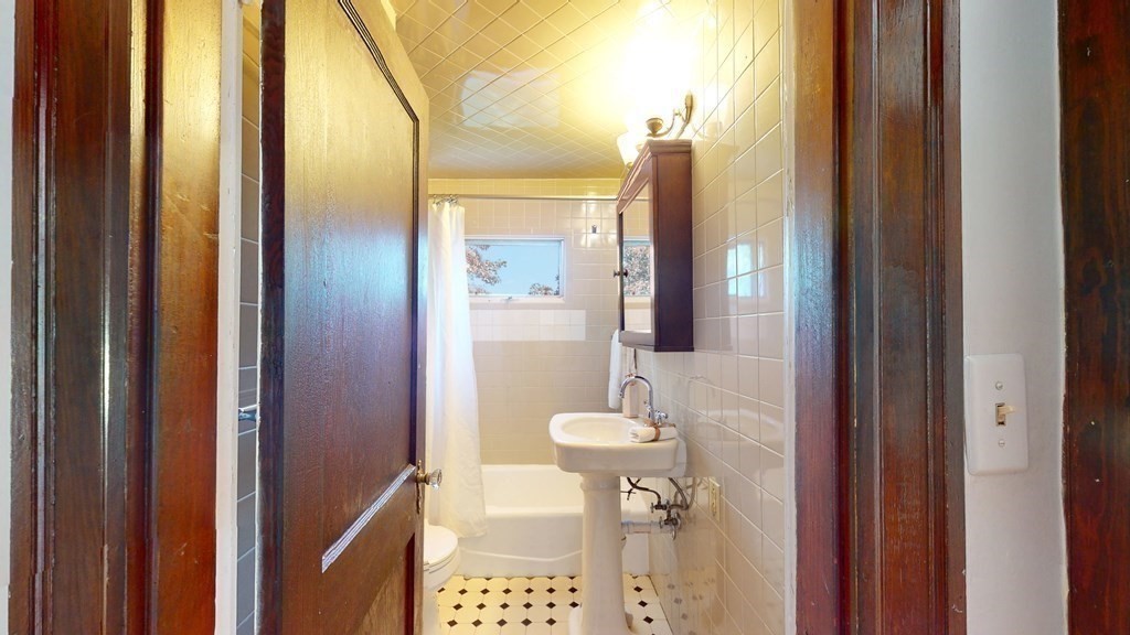 82 Roberts Road Medford, MA 02155 - Photo 15 of 30 a bathroom with a shower and toilet