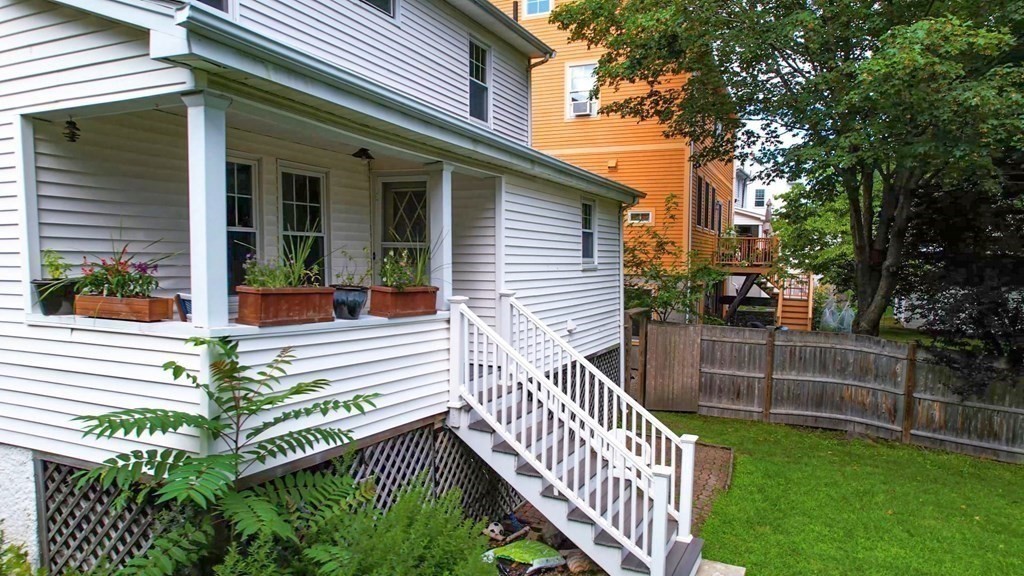 82 Roberts Road Medford, MA 02155 - Photo 23 of 30 a view of a house with a yard and wooden fence