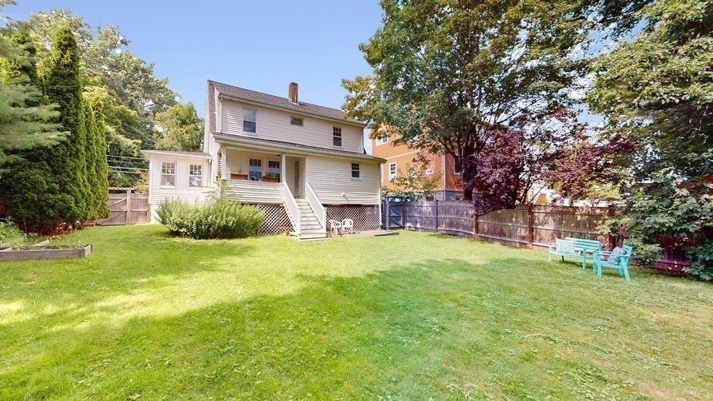 82 Roberts Road Medford, MA 02155 - Photo 25 of 30 a backyard of a house with a garden and outdoor seating