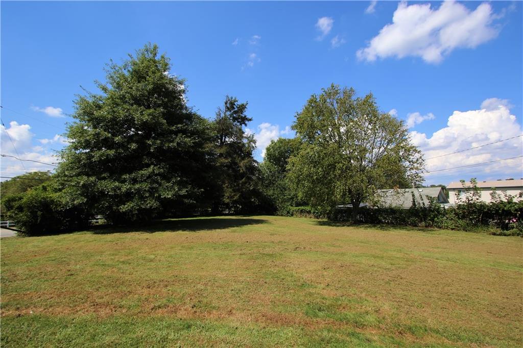 453 Simpson Howell Road Elizabeth, PA 15037 - Photo 12 of 25 Detail View of the Tree Lined, Private & Flat Font Yard! Wooden Fencing is Present by the Trees.