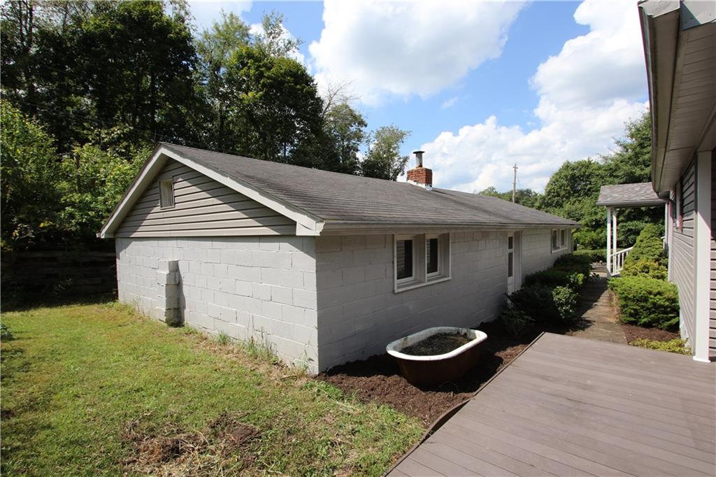 453 Simpson Howell Road Elizabeth, PA 15037 - Photo 3 of 25 HUGE Detached Garage has a Fireplace, Man Door Side Entrance, 2 Automatic Garage Doors, and a Covered Carport on other Side.