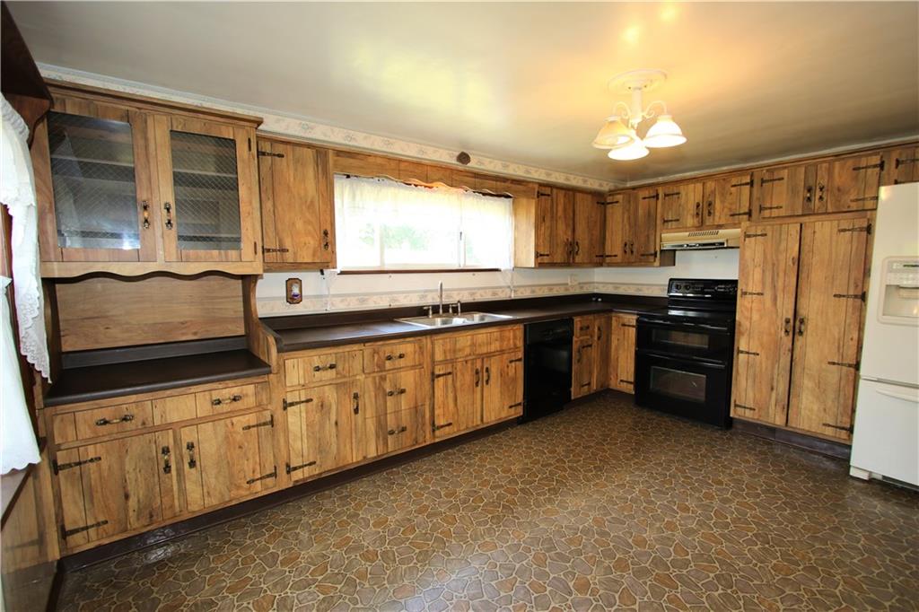 453 Simpson Howell Road Elizabeth, PA 15037 - Photo 5 of 25 15x11 Eat in Kitchen has A Wall of Cabinetry, Vinyl Flooring, and a Large Wooden Pantry with Bonus Shelving (Located Next to Refrigerator). Appliances are Included in Sale!