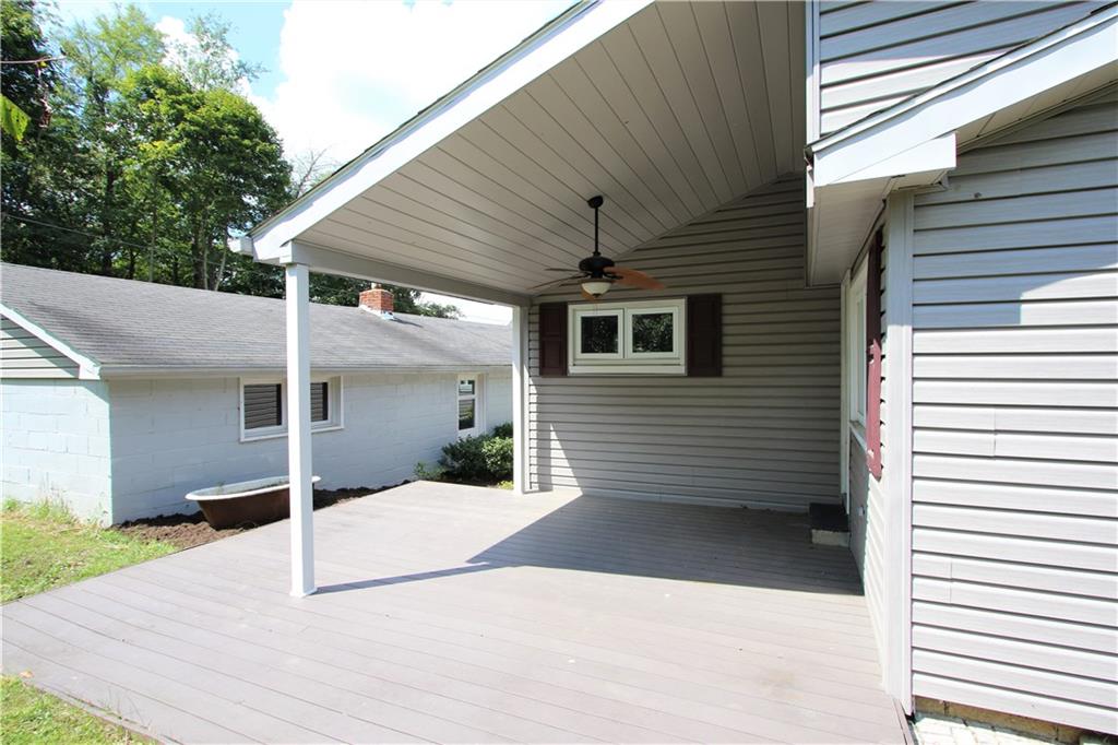 453 Simpson Howell Road Elizabeth, PA 15037 - Photo 9 of 25 17x15 Covered Back Patio w/Ceiling Fan. Concrete Walkway leads to Man Door of Garage and Front of Home. Door on Left Leads to the Second Bedroom.