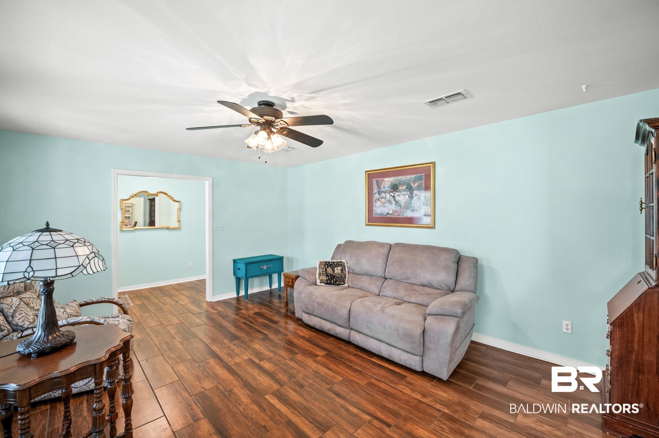 2553 Santa Rosa Drive Lillian, AL 36549 - Photo 11 of 51 Living room with dark wood-style flooring, visible vents, ceiling fan, and baseboards