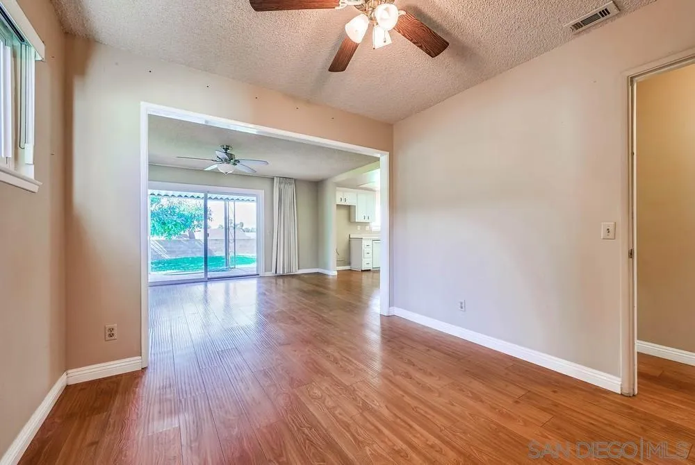 5970 Eucalyptus Drive Highland, CA 92346 - Photo 13 of 26 a view of an empty room with wooden floor and a window