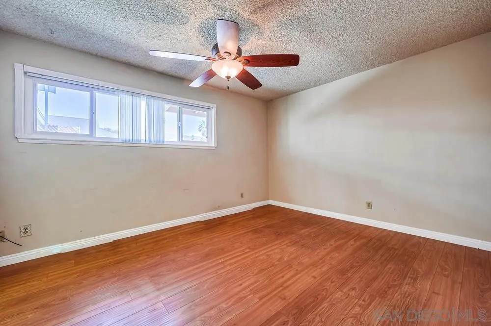 5970 Eucalyptus Drive Highland, CA 92346 - Photo 15 of 26 a view of an empty room with wooden floor and a window