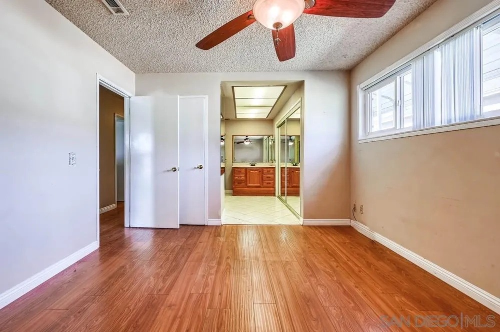 5970 Eucalyptus Drive Highland, CA 92346 - Photo 16 of 26 a view of an empty room with wooden floor and a window