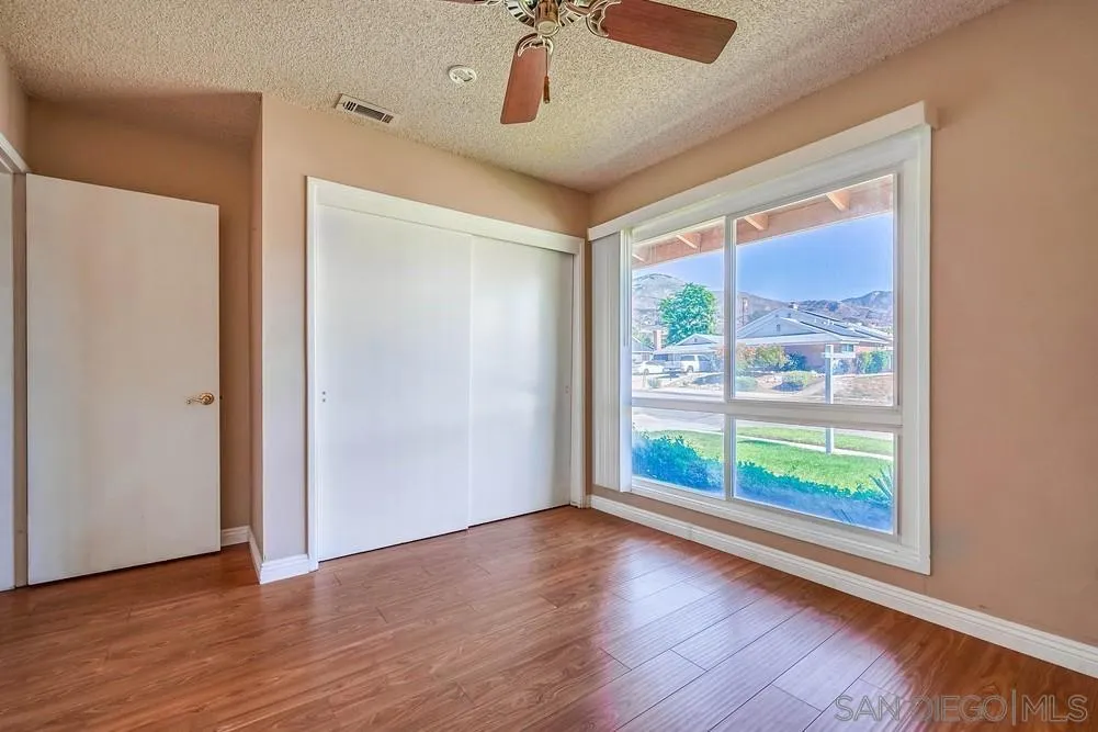 5970 Eucalyptus Drive Highland, CA 92346 - Photo 18 of 26 a view of room with window and wooden floor
