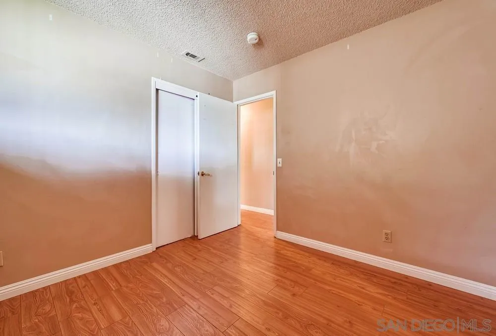 5970 Eucalyptus Drive Highland, CA 92346 - Photo 19 of 26 a view of an empty room with wooden floor