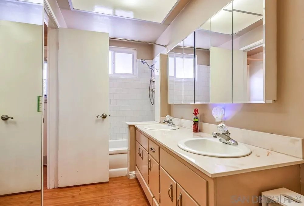 5970 Eucalyptus Drive Highland, CA 92346 - Photo 20 of 26 a bathroom with a sink a mirror and a shower