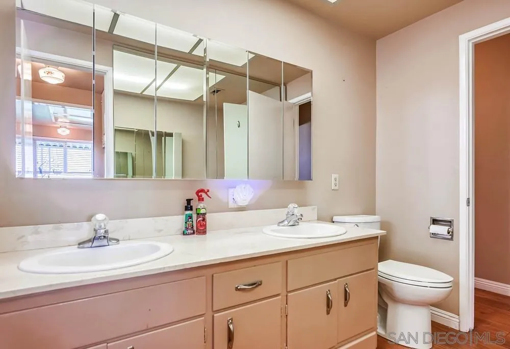5970 Eucalyptus Drive Highland, CA 92346 - Photo 21 of 26 a bathroom with a sink a toilet and a mirror